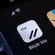 A phone with the Wickr and Amazon shopping app icons on top of a laptop keyboard.